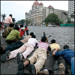 Media persons lying o the ground.