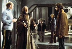 Alec Guinness and George Lucas confer on the set of 'Star Wars.'
