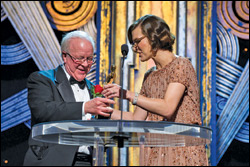 Actress Milla Jovovich presents Douglas Trumbull with the Gordon E. Sawyer Award during the Acad’s Sci-Tech ceremonies Saturday.