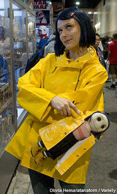 An attendee walks the convention floor as Coraline.