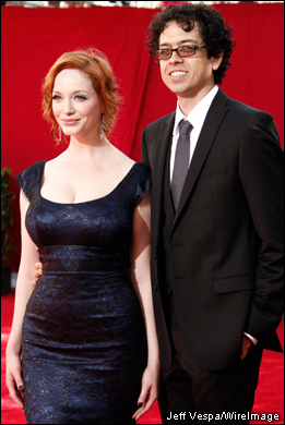 'Mad Men' star Christina Hendricks and fiance actor Geoffrey Arend stop for pictures before entering the Nokia Theatre for the 61st Primetime Emmy Awards.